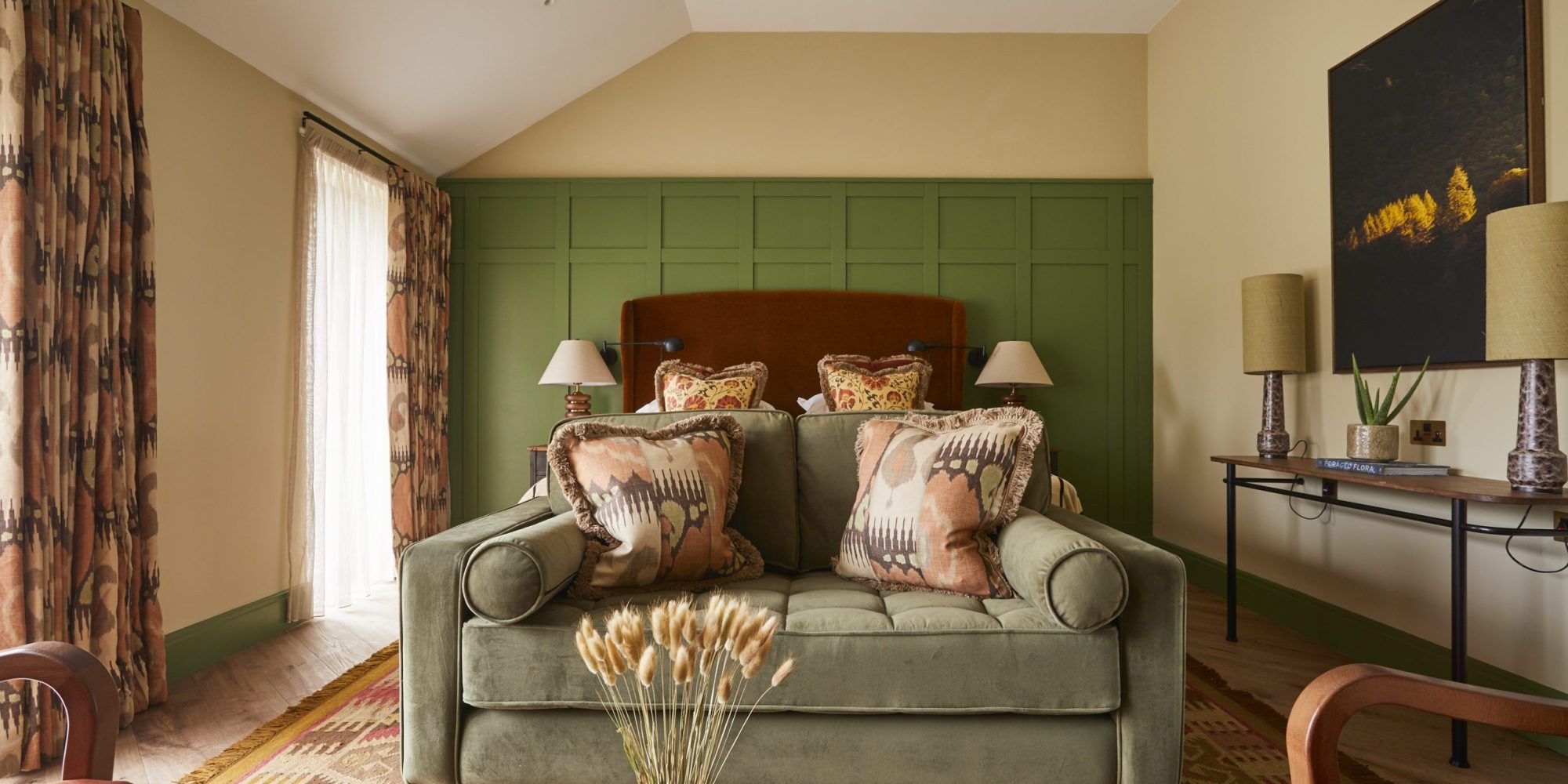 A spacious and modern superior bedroom at Rothay Manor Hotel with a large bed, soft lighting, and calming, neutral decor.